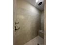 Modern walk-in shower with beige tiles, seating, and sleek fixtures at 240 Gallery Dr # 303, Spring Lake, NC 28390