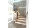 Elegant staircase featuring wooden handrails and dark metal balusters, adding a touch of modern sophistication at 298 Dove Rd, Cameron, NC 28326