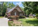 Stunning stone house with a perfectly landscaped yard and mature trees at 3027 Carrington Ln, Sanford, NC 27330