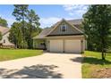 Inviting two-story home featuring a convenient two-car garage and well-maintained lawn in a serene setting at 35 Pineridge Cv, Sanford, NC 27332
