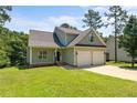 Inviting two-story home featuring a convenient two-car garage and well-maintained lawn in a serene setting at 35 Pineridge Cv, Sanford, NC 27332
