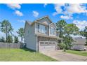 Charming two-story home with stone accents, attached two-car garage, and well-maintained lawn at 442 Kentucky Derby Ln, Lillington, NC 27546