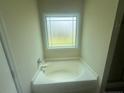 Relaxing soaking tub with a large window in the bathroom at 138 Gold Ct, Broadway, NC 27505