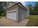 Spacious two-car garage with carriage-style doors and side entry offer convenience and additional storage at 138 Gold Ct, Broadway, NC 27505