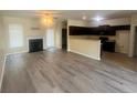 Open concept living room and kitchen with fireplace and modern finishes at 138 Gold Ct, Broadway, NC 27505