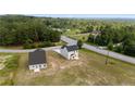 Aerial view of new home, showcasing the roofline, with green space and surrounding treeline at 15 Red Bird Dr, Cameron, NC 28326