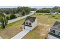 New construction with a two-car garage, long driveway, green space, and views of surrounding woods at 15 Red Bird Dr, Cameron, NC 28326