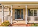 Close up of the front door featuring white railings, a gray front door opened to the interior at 280 Hillandale Rd, Spring Lake, NC 28390
