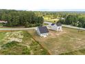 An aerial view of two-story homes with gray exteriors sitting on large lots on a sunny day at 29 Red Bird Dr, Cameron, NC 28326