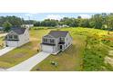 Charming two-story home with a gray exterior, a two-car garage, and a well-manicured lawn at 29 Red Bird Dr, Cameron, NC 28326