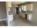 Bright kitchen featuring white cabinets, marble countertops, and ample counter space at 707 N Wilson Ave, Dunn, NC 28334