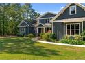 Charming two-story home featuring a manicured lawn and mature landscaping at 1063 Pineywood Church Rd, Cameron, NC 28326