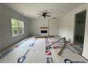 Spacious living room features a fireplace, large window, recessed lighting, and neutral paint at 138 Travelers Way, Lillington, NC 27546