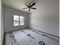 Bright bedroom featuring a ceiling fan and a window offering natural light at 151 Travelers Way, Lillington, NC 27546