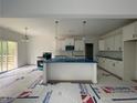 Open-concept kitchen with white cabinets, modern appliances, and center island at 151 Travelers Way, Lillington, NC 27546