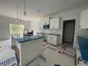 Spacious kitchen with island, white cabinetry, and stainless steel appliances at 151 Travelers Way, Lillington, NC 27546
