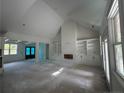 Spacious living room featuring large windows, built-in shelving and fireplace at 27 Lookout Pt, Sanford, NC 27332