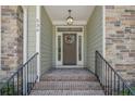 Inviting entryway with brick steps, stone accents and decorative wreath, providing a warm welcome at 530 Anderson Creek Dr, Spring Lake, NC 28390