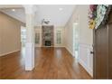 Bright living room featuring a stone fireplace, hardwood floors, and large windows for natural light at 530 Anderson Creek Dr, Spring Lake, NC 28390