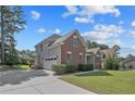 Two-story brick home with a paved driveway and manicured lawn, showcasing classic design and curb appeal at 55 Blue Pine Dr, Spring Lake, NC 28390