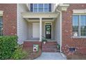 Inviting front porch with brick accents, classic columns, and a welcoming entrance with decorative touches at 55 Blue Pine Dr, Spring Lake, NC 28390