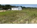New single story construction with white siding, black roof, and green grass at 5964 Godwin Lake Rd, Benson, NC 27504
