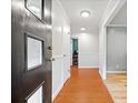 Entry way and hallway with white walls, wood floors, and neutral paint colors at 602 Canterbury Rd, Sanford, NC 27330