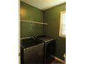 Laundry room with side by side washer and dryer and wire shelving at 108 Shady Meadows Ln, Clayton, NC 27520