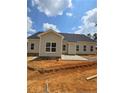 Newly constructed backyard with a small concrete patio overlooking freshly graded land ready for landscaping at 46 Poplar Dr, Spring Lake, NC 28390