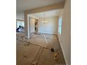 Bright dining room featuring modern chandelier and large windows during the flooring installation process at 46 Poplar Dr, Spring Lake, NC 28390
