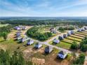 Aerial shot of a new community featuring single-Gathering homes with green lawns surrounded by woods at 534 Stadium Drive, Cameron, NC 28326