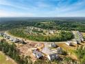 Panoramic aerial view of a sprawling residential community surrounded by lush greenery and trees at 560 Stadium Drive, Cameron, NC 28326
