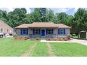 Traditional home with a welcoming front porch and beautiful landscaping at 106 Deep Forest Dr, Durham, NC 27713