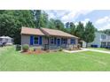 Well-manicured lawn and landscaped garden accent this cozy single-story home at 106 Deep Forest Dr, Durham, NC 27713