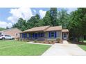 View of the home with manicured lawn and driveway on a sunny day at 106 Deep Forest Dr, Durham, NC 27713