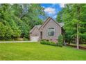 Well-maintained single-Gathering home with lush green lawn and an attached two-car garage and inviting front entrance at 125 Lakeforest Trl, Sanford, NC