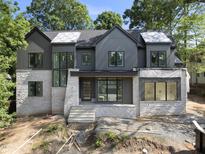 New construction modern home featuring a stone facade, dark siding, and large windows at 508 Northwood Dr, Raleigh, NC 27609