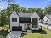 Beautiful two-story home with black trim windows and a well-manicured lawn at 5305 Dixon Dr, Raleigh, NC 27609