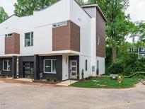 New, modern townhome showcasing its exterior with brick and modern lines at 1527 Havenmont Ct, Raleigh, NC 27608