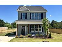 Charming two-story home with gray siding, black shutters, and manicured front lawn at 40 Longbow Dr, Middlesex, NC 27557