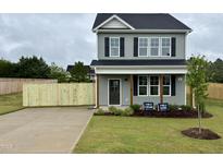 Charming two-story home with gray siding, black shutters, and a well-manicured front lawn at 40 Longbow Dr, Middlesex, NC 27557