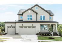 Beautiful two-story home featuring a three car garage, covered porch and manicured lawn at 6059 Scalybark Road, Durham, NC 27712