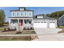 Charming two-story home with a welcoming front porch and attached two-car garage at 6060 Scalybark Rd, Durham, NC 27712