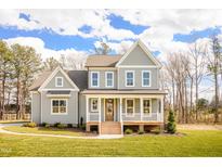 Charming two-story home featuring a welcoming front porch and beautifully landscaped front yard at 30 Imperial Oaks Ct, Youngsville, NC 27596