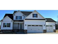Two story house with white siding, gray accents, and a three-car garage at 98 Prency Ln, Middlesex, NC 27557