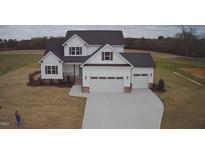 Charming two-story home featuring a black roof, a two-car garage, and a large concrete driveway at 98 Prency Ln, Middlesex, NC 27557
