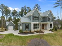 Charming two-story home featuring a well-manicured lawn, elegant stone accents, and a detached garage at 3908 Sage Ct, Wake Forest, NC 27587