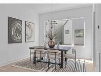 Bright dining room with modern light fixture and black and white striped rug at 2014 Moody Ln, Durham, NC 27701