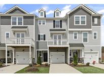 Charming townhomes featuring a two-car garage, balcony, and craftsman-style architectural elements at 125 Sugar Run Dr # 26, Fuquay Varina, NC 27526