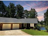 Charming brick home with a two-car garage near the lake, offering serene sunset views at 3309 Westcott Cir, Sanford, NC 27330